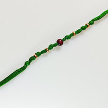 Load image into Gallery viewer, Handmade Rakhi with green thread, chandan bead and gold plating