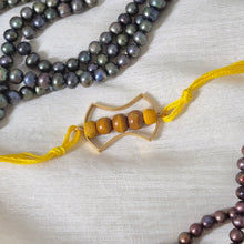 Load image into Gallery viewer, Gold Frame Rakhi with yellow Thread and beads