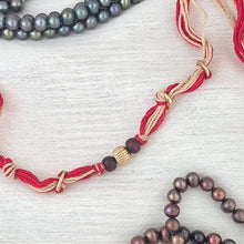 Load image into Gallery viewer, Handmade Rakhi with red and beige thread with chandan bead and gold plating
