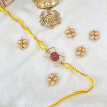 Load image into Gallery viewer, Rudraksha Rakhi with yellow thread and gold frame