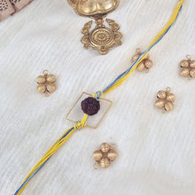 Load image into Gallery viewer, Rudraksha Rakhi with yellow and blue thread with gold square frame