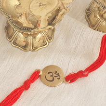 Load image into Gallery viewer, Gold Plated Om Rakhi with red thread