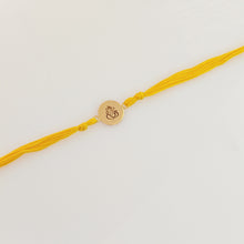 Load image into Gallery viewer, Gold plated Ganesh Rakhi with yellow thread
