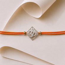 Load image into Gallery viewer, Om Silver-Plated Rakhi with round orange cord