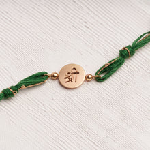 Load image into Gallery viewer, Shree Rakhi with Beads entwined with green &amp; glitter thread
