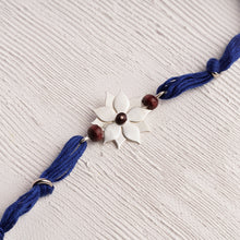 Load image into Gallery viewer, Flower Rakhi with Chandan Beads on Blue thread
