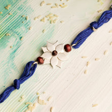 Load image into Gallery viewer, Flower Rakhi with Chandan Beads on Blue thread
