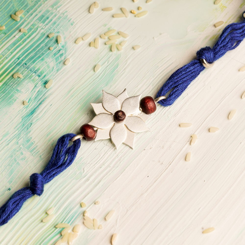 Flower Rakhi with Chandan Beads on Blue thread