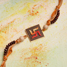 Load image into Gallery viewer, Handpainted Swastika Rakhi on wood with chandan beads on jute thread

