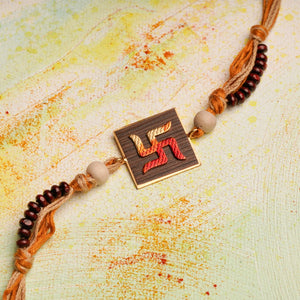 Handpainted Swastika Rakhi on wood with chandan beads on jute thread