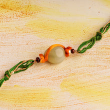 Load image into Gallery viewer, Green Chalcedony Gold-plated Om Rakhi with Glitter thread for that March Sibling
