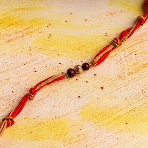 Rakhi with Spiritual Chandan Beads with Red & Jute Tie Up Thread