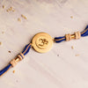 Om Rakhi Charm with Tulsi Beads on Blue thread