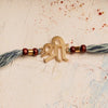 Shree Rakhi with Scroll & Spiritual Chandan Beads on Denim Thread