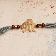 Load image into Gallery viewer, Shree Rakhi with Scroll &amp; Spiritual Chandan Beads on Denim Thread
