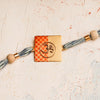 Handpainted Orange Om Rakhi with Scroll