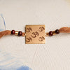 Square Laser Om Rakhi with Chandan Beads