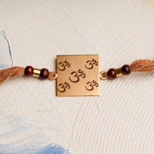 Load image into Gallery viewer, Square Laser Om Rakhi with Chandan Beads
