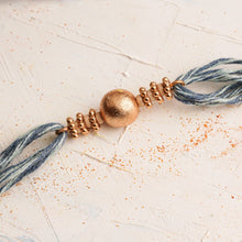 Load image into Gallery viewer, Metal Ball Rakhi with Denim Thread &amp; Tulsi Beads
