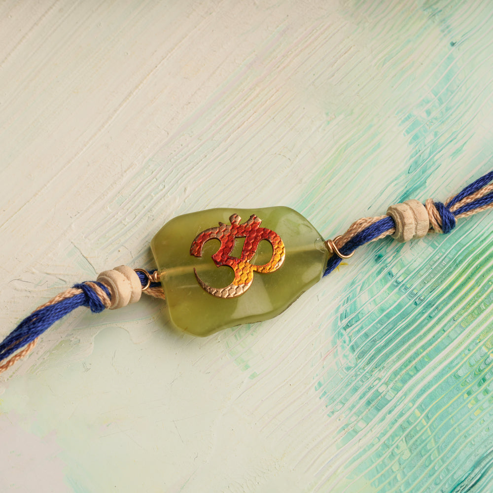 Handpainted Om Rakhi with a Green Stone & Tulsi Beads