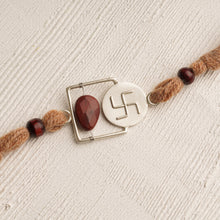 Load image into Gallery viewer, 92.5 Silver Plated Swastik Rakhi with a Red Stone
