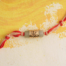 Load image into Gallery viewer, Gold Plated Om Rakhi On Grey Stone
