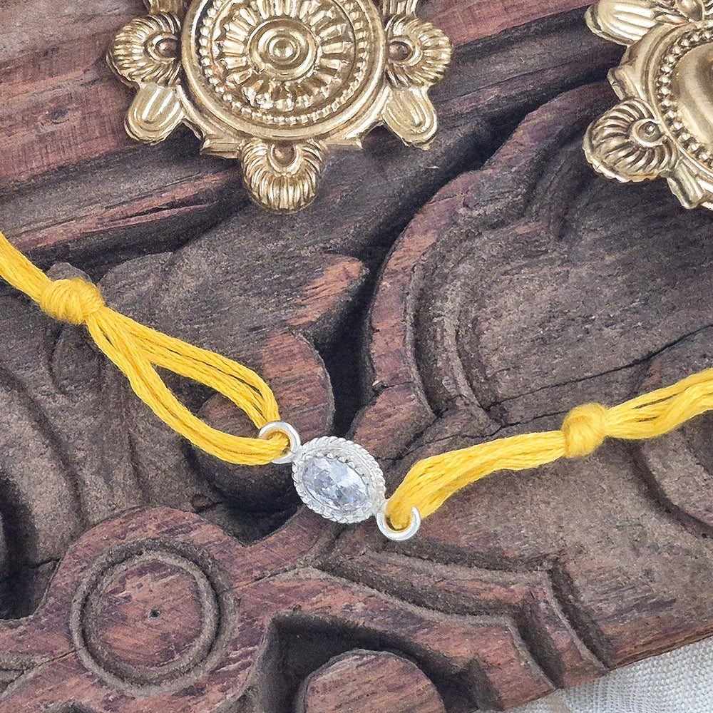 Crystal Silver Rakhi with yellow thread – Suhani Pittie