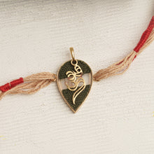 Load image into Gallery viewer, 22K Gold Double Om Rakhi with brown &amp; red thread changeable into a pendant
