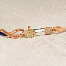 Load image into Gallery viewer, 22K Gold Om Rakhi on Acryclic Tube with Tie Up thread
