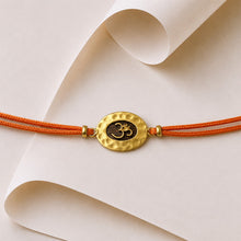 Load image into Gallery viewer, Gold Om Rakhi with Orange Cord
