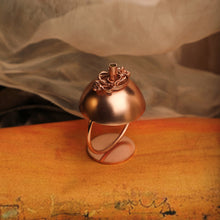 Load image into Gallery viewer, Copper plated spherical incense stick holder with circular base and ornate entwined detailing
