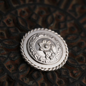 92.5 Sterling Silver Coin with entwined border and bold floral emblem detailing