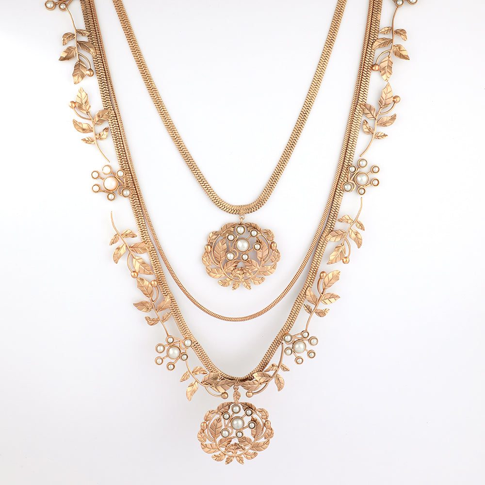 Gold toned layered necklace with serrate and pearl embellishment