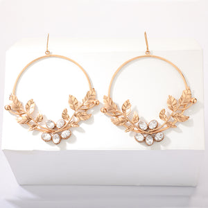 Gold toned serrate and crystal hoops