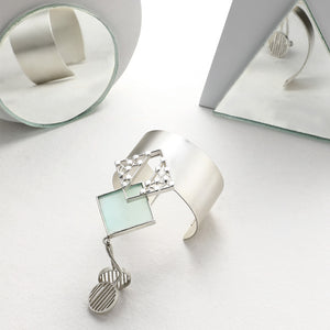 SILVER TONED CUFF WITH DOTTED CYAN ACRYLIC RHOMBUS & PENDULUM PENDANTS