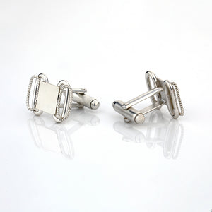 Silver toned cufflinks with oval twisted wire detail