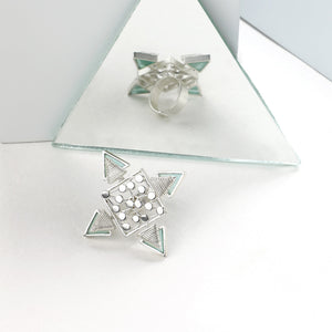 SILVER TONED DOTTED RHOMBUS RING WITH COILED CYAN ACRYLIC TRIANGLES WORN BY MALAVIKA NAIR