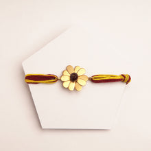 Load image into Gallery viewer, 22K GOLD PLATED FLORAL PETALS RAKHI WITH RED AND YELLOW TIEUPS
